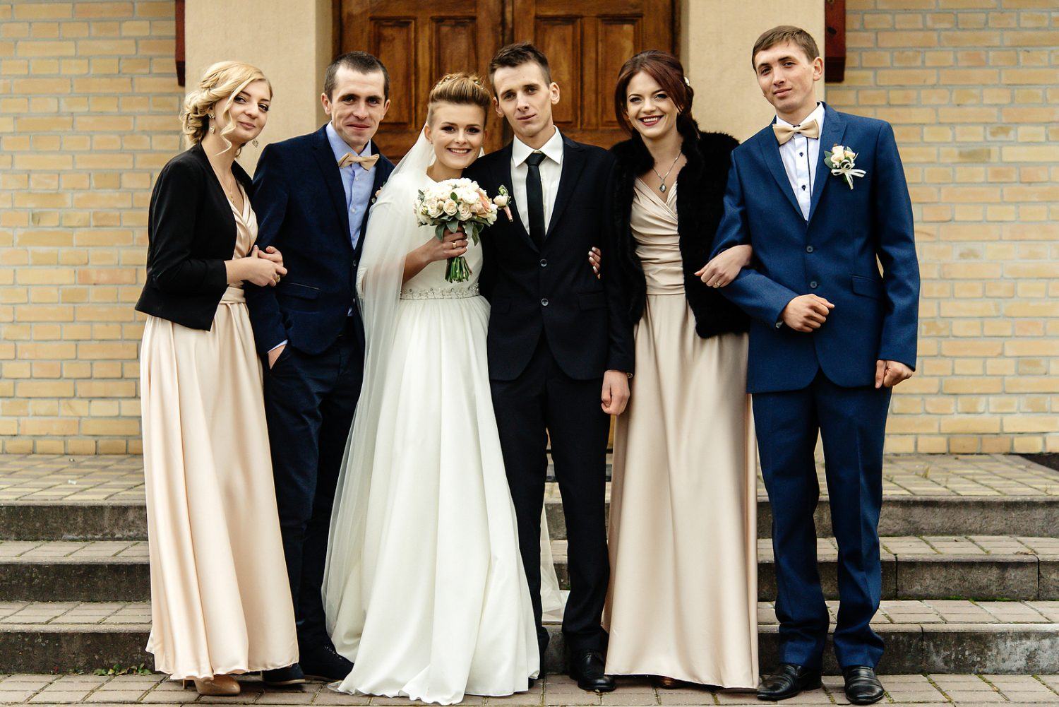 Bride And Groom With Happy Groomsman And Bridesmaid Posing At Ch